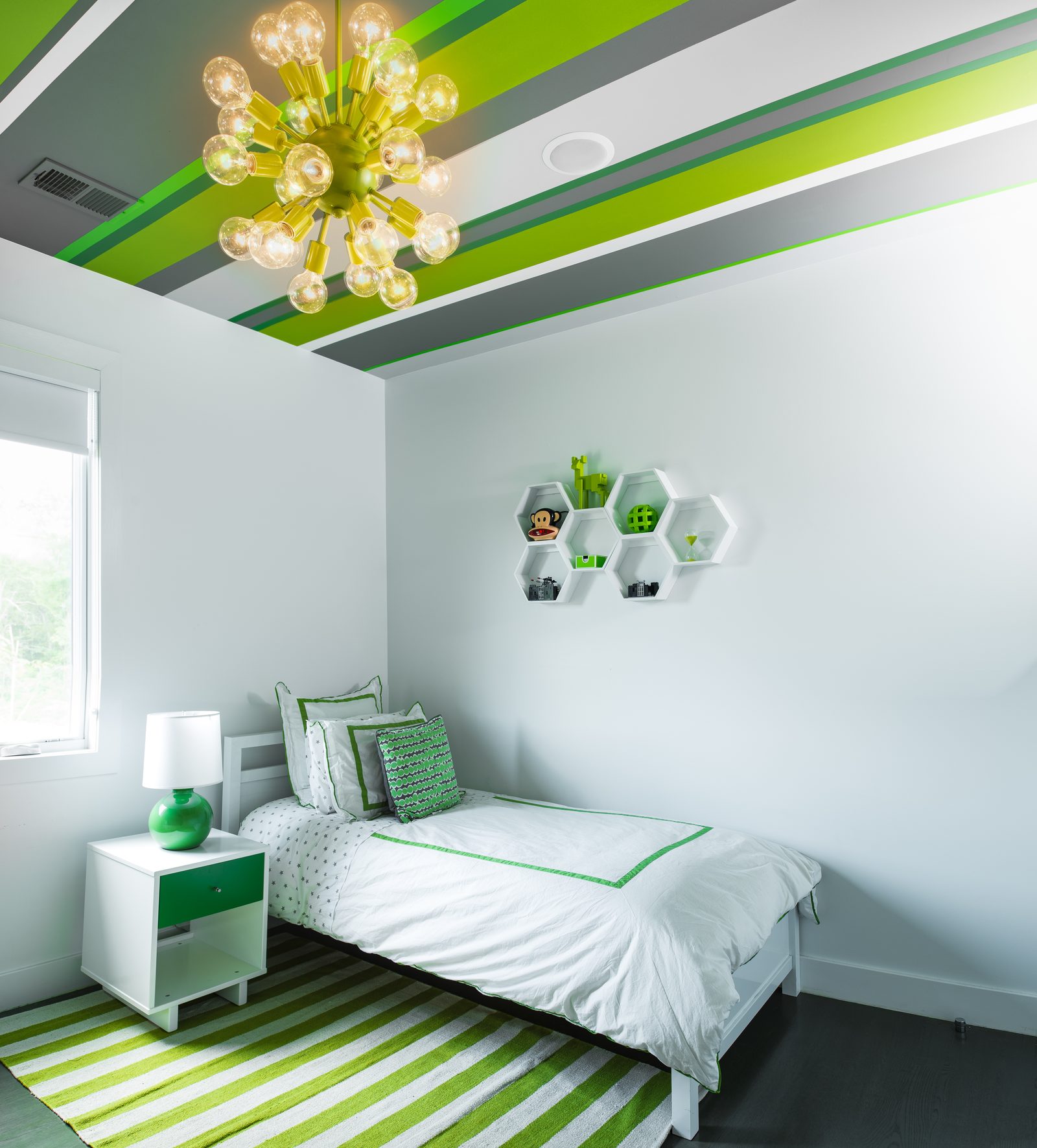 Green themed bedroom with honeycomb shelves